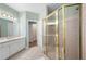 Bright bathroom featuring a vanity with a sink and mirror next to a glass enclosed shower at 223 Oak Grove Dr, Dallas, GA 30157