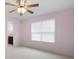 Cozy bedroom featuring a ceiling fan and natural light streaming through the window at 223 Oak Grove Dr, Dallas, GA 30157