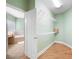 Walk-in closet next to the bathroom with white shelving and hardwood floors at 223 Oak Grove Dr, Dallas, GA 30157