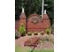 Charming Oak Grove Estates entrance featuring brick signage, manicured landscaping, and decorative lion statues at 223 Oak Grove Dr, Dallas, GA 30157