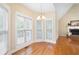 Sun-filled dining area with hardwood floors and views of the backyard and living room at 223 Oak Grove Dr, Dallas, GA 30157