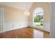 Elegant dining room with wainscoting, chandelier, and large arched window at 223 Oak Grove Dr, Dallas, GA 30157