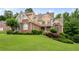 Beautiful two-story home with brick accents, manicured lawn, and mature landscaping at 223 Oak Grove Dr, Dallas, GA 30157