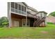 View of the back of the home showcasing a screened porch and deck at 223 Oak Grove Dr, Dallas, GA 30157