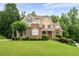 Charming two-story home with brick facade, well-maintained lawn, and mature trees at 223 Oak Grove Dr, Dallas, GA 30157