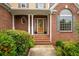 Inviting front porch with brick steps and columns, leading to an elegant front door at 223 Oak Grove Dr, Dallas, GA 30157