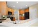 Well-lit kitchen features wood cabinets, black appliances, tile backsplash, and access to the stairway at 223 Oak Grove Dr, Dallas, GA 30157