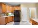 Charming kitchen with wood cabinets, stainless steel refrigerator, and tile flooring at 223 Oak Grove Dr, Dallas, GA 30157