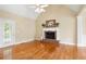 Bright living room featuring a brick fireplace, hardwood floors, and access to the backyard at 223 Oak Grove Dr, Dallas, GA 30157