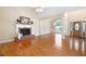 Open-concept living area with fireplace, hardwood floors, and decorative columns at 223 Oak Grove Dr, Dallas, GA 30157