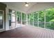 Relaxing screened porch with wooded view and ceiling fan at 223 Oak Grove Dr, Dallas, GA 30157