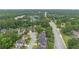 Wide aerial view of a residential area, highlighting the homes, tree coverage, and nearby roadways at 3032 Montclair Se Cir, Smyrna, GA 30080