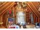 Unfinished attic space with exposed beams, a window and assorted stored decorations at 3032 Montclair Se Cir, Smyrna, GA 30080