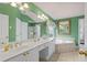 Green bathroom features a double sink, soaking tub, and shower, creating a luxurious space at 3032 Montclair Se Cir, Smyrna, GA 30080