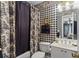 Bathroom with black and white patterned wallpaper, a shower curtain, and a vanity at 3032 Montclair Se Cir, Smyrna, GA 30080