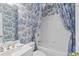 Elegant bathroom with blue and white patterned wallpaper, bathtub, and sink at 3032 Montclair Se Cir, Smyrna, GA 30080