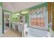 Bathroom with a tub, decorative window, double vanity and green patterned wallpaper at 3032 Montclair Se Cir, Smyrna, GA 30080