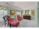 Bright bedroom features two pink sofa chairs, shuttered windows, and light green walls at 3032 Montclair Se Cir, Smyrna, GA 30080