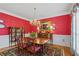 Formal dining room with red walls, chandelier, china cabinet, and a wooden table at 3032 Montclair Se Cir, Smyrna, GA 30080
