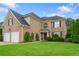 Beautiful two-story brick house with a green lawn and a two-car garage at 3032 Montclair Se Cir, Smyrna, GA 30080