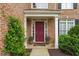 Inviting front entrance with a burgundy door, potted plants, and white trim at 3032 Montclair Se Cir, Smyrna, GA 30080