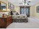 Spacious main bedroom featuring a decorative ceiling fan, patterned bedding, and elegant decor at 3032 Montclair Se Cir, Smyrna, GA 30080