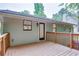 Back deck of house features light green siding and stairs leading down to backyard at 3960 Rocmar Dr, Snellville, GA 30039