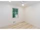 Neutral bedroom with wood-look floors and a bright window to outside at 3960 Rocmar Dr, Snellville, GA 30039