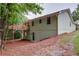 Back exterior view of house with wooden deck, green siding, and backyard at 3960 Rocmar Dr, Snellville, GA 30039