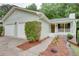A well maintained single-story home with a two-car garage and landscaped front yard at 3960 Rocmar Dr, Snellville, GA 30039