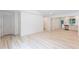 Spacious living area with light-colored flooring leading to the kitchen and backyard access at 3960 Rocmar Dr, Snellville, GA 30039