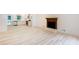 Bright, open-concept living area with a fireplace, hardwood floors, and a view to the kitchen at 3960 Rocmar Dr, Snellville, GA 30039
