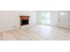 Bright living room with fireplace, large window, and wood-look flooring at 3960 Rocmar Dr, Snellville, GA 30039