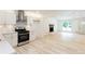Open-concept living area with fireplace, lots of natural light and wood flooring at 3960 Rocmar Dr, Snellville, GA 30039