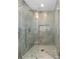 Elegant walk-in shower with marble tile surround and glass doors at 3960 Rocmar Dr, Snellville, GA 30039