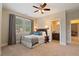 Bedroom featuring a window, carpet floor, and ensuite bathroom at 4224 Dogwood Bend Park, Berkeley Lake, GA 30096