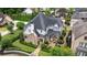 Stunning aerial view of the gray house with manicured lawns, a stone patio, and a beautiful backyard at 4224 Dogwood Bend Park, Duluth, GA 30096