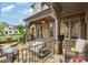 Inviting back porch with an outdoor seating area, brick pillars, stone floor, ceiling fan, and manicured lawn at 4224 Dogwood Bend Park, Duluth, GA 30096
