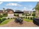 Grassy backyard with a round patio set, a gas grill, black umbrella, and an outdoor table set at 4224 Dogwood Bend Park, Duluth, GA 30096