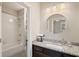 Well-lit bathroom features a granite countertop, a decorative mirror, and a white tiled shower-over-tub at 4224 Dogwood Bend Park, Duluth, GA 30096