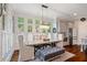 Bright dining room with shiplap walls, chandelier lighting, and many windows overlooking the landscaped yard at 4224 Dogwood Bend Park, Duluth, GA 30096