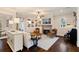 Spacious living room featuring built-in bookshelves, fireplace, and views to dining room and kitchen at 4224 Dogwood Bend Park, Duluth, GA 30096