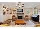 Comfortable living room features a fireplace, built-in bookshelves, and a piano at 4224 Dogwood Bend Park, Duluth, GA 30096