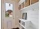 Clean mudroom area with white shelves, wood-look floors, storage baskets, and a doggie door at 4224 Dogwood Bend Park, Duluth, GA 30096