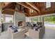 Outdoor living area with stone fireplace, comfortable seating, and view of the pool at 4224 Dogwood Bend Park, Duluth, GA 30096