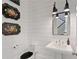 Stylish powder room featuring white shiplap walls, decorative trays, mirror, and vintage fixtures at 4224 Dogwood Bend Park, Duluth, GA 30096