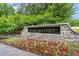 Stone sign for the River District community surrounded by colorful flowers at 4224 Dogwood Bend Park, Duluth, GA 30096