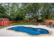 Picture perfect backyard view showing the in-ground pool, playground, privacy fence and shed at 657 Polk Nw St, Marietta, GA 30064