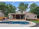Large backyard with an in-ground pool, covered deck, and manicured landscaping at 657 Polk Nw St, Marietta, GA 30064