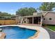 Gorgeous backyard featuring pool, patio, outdoor kitchen, wood deck, and lush green lawn at 657 Polk Nw St, Marietta, GA 30064